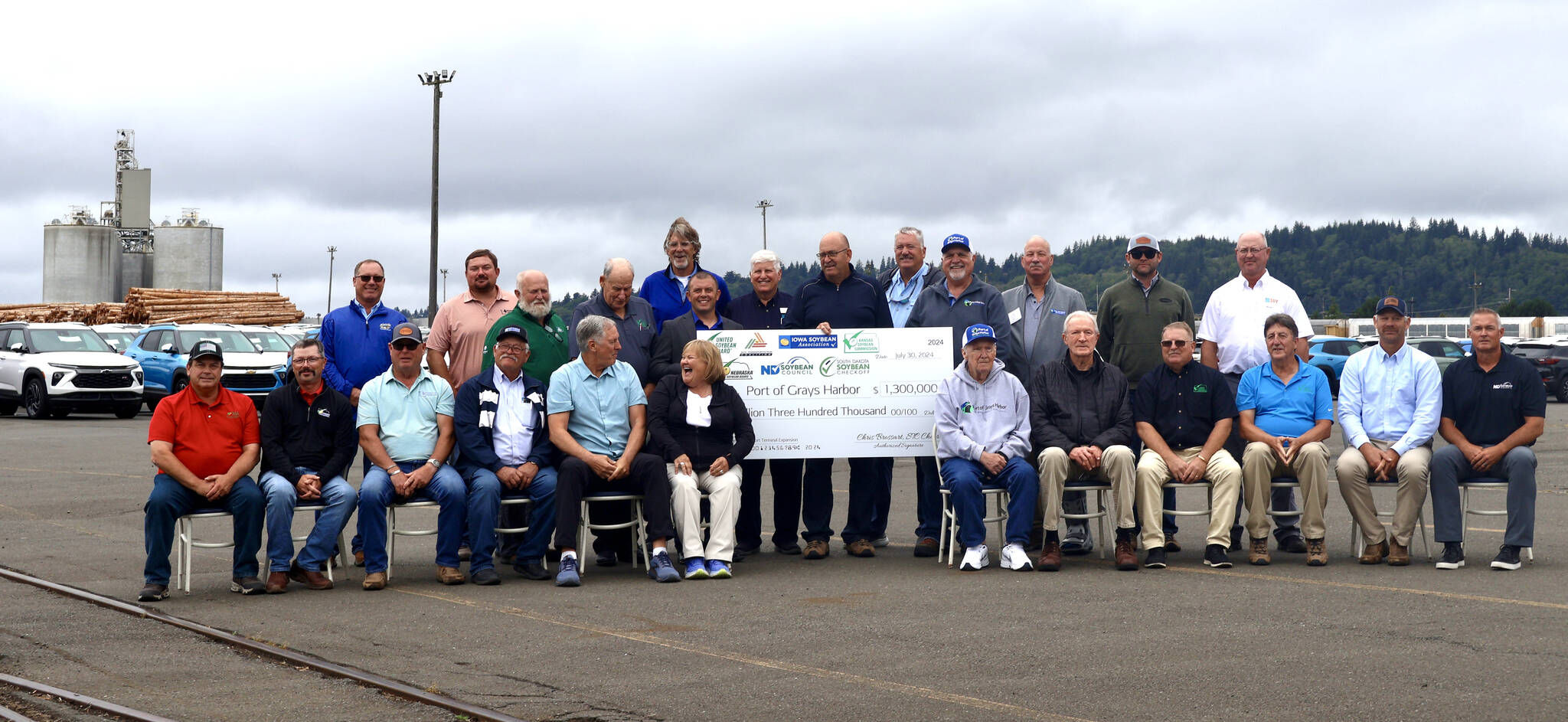 Officials from the Port of Grays Harbor and various soybean farming and transport groups from across the Midwest pose with a ceremonial check for $1.3 million on Tuesday in honor of the partnership. (Michael S. Lockett / The Daily World)