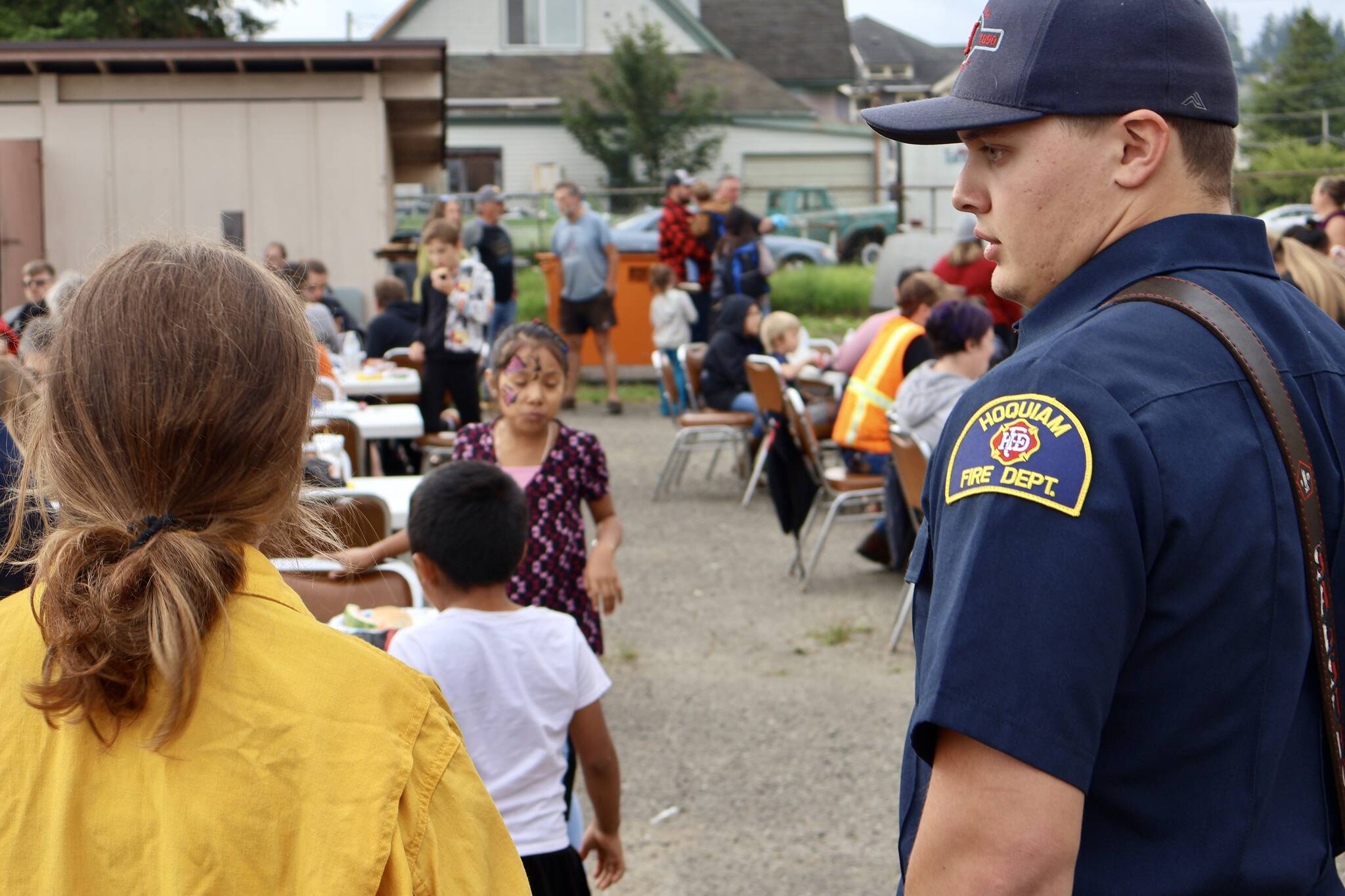 Firefighters and police take a moment to mingle with residents during a National Night Out event in Hoquiam. (Michael S. Lockett / The Daily World)