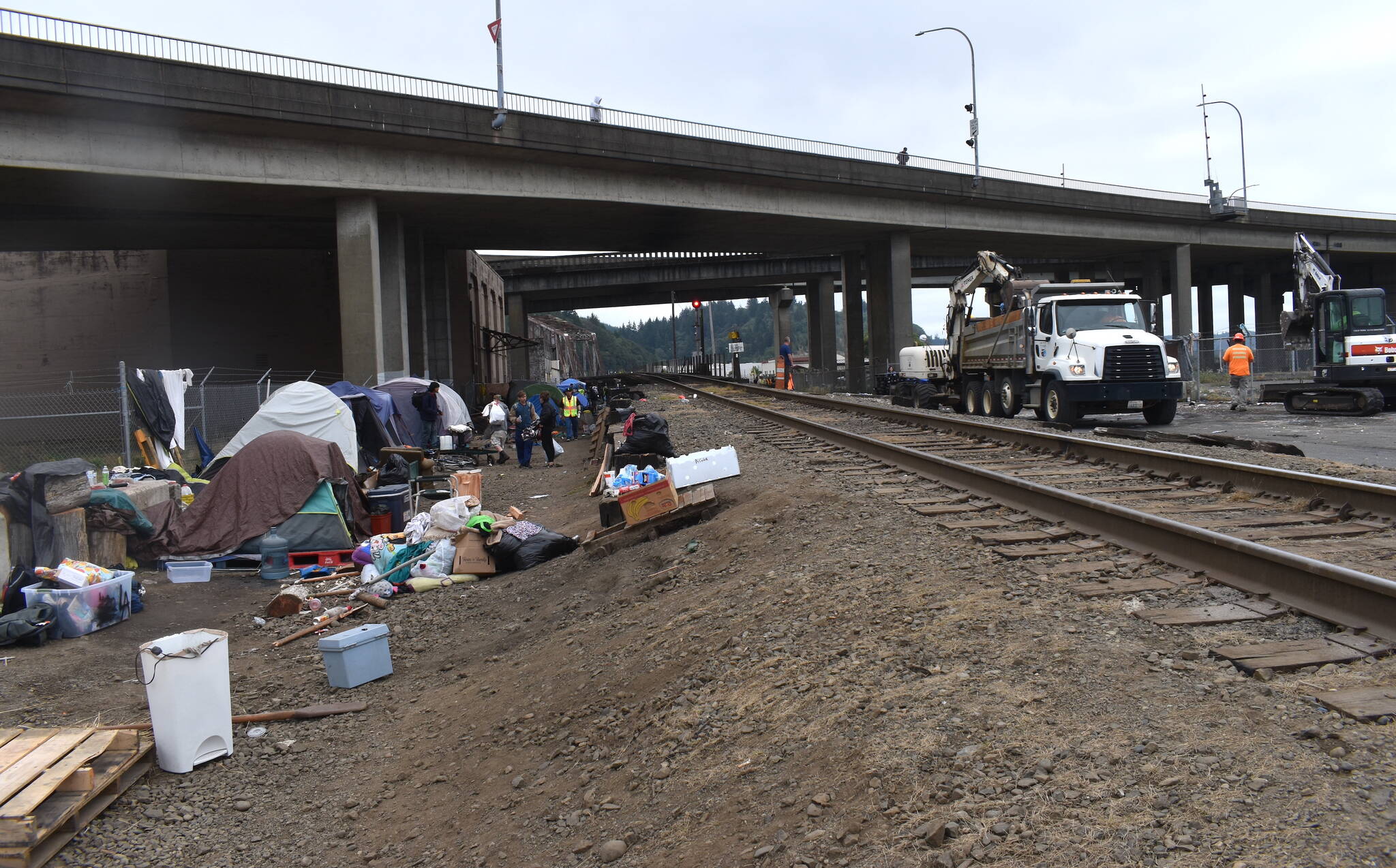 Matthew N. Wells / The Daily World
Much of the encampment was cleaned out by mid-morning on Wednesday, but there were unhoused people there figuring out what to do as a lot of city staffers, nonprofits and other people involved, tried to help move them out.