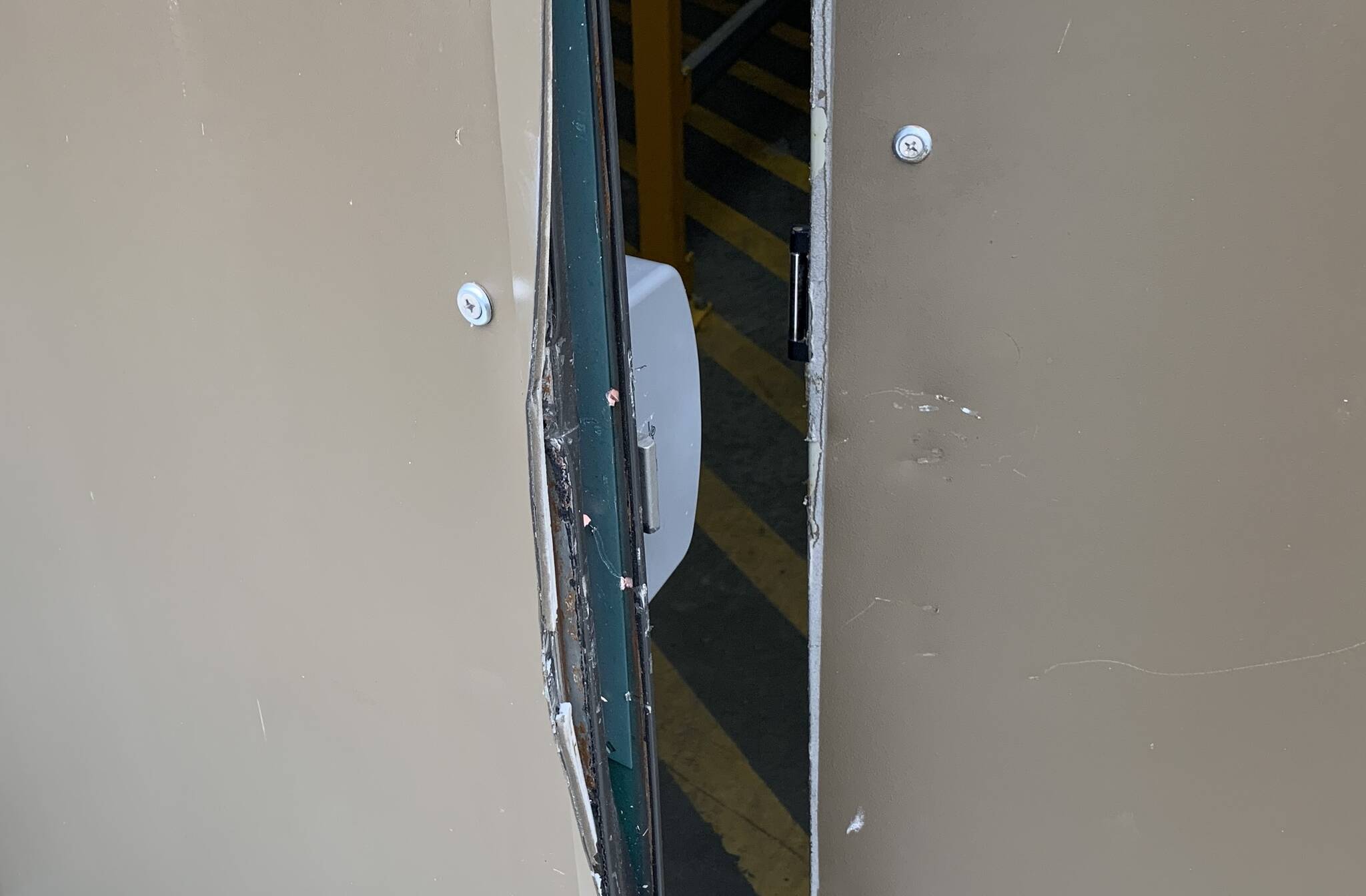 Damage to the door as a result of a forced entry into a business during a burglary spree is visible. (Courtesy photo / GHSO)