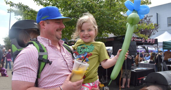 Matthew N. Wells / The Daily World
Ian VanDooren carries his son Thomas on his back and holds his daughter Emily. The VanDoorens had a ball at Aberdeen Summerfest. They enjoyed the balloons, the lemonde and the chicken Yakisoba. While they only tasted meat from a couple barbecue teams, they were happy. That’s what Aberdeen Summerfest is all about, to get friends and families, of all-ages, downtown.