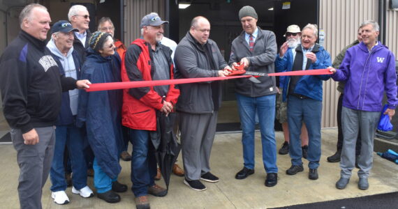 Matthew N. Wells / The Daily World
Hoquiam Mayor Ben Winkelman and Aberdeen Mayor Doug Orr cut the ceremonial ribbon for the opening of the Fry Creek Pump Station on a drizzly Tuesday afternoon. Along with Orr and Winkelman, many other people were in attendance, including city, county and state representatives, members of the Office of Chehalis Basin, representatives from Quigg Bros, Inc., and HDR Engineering Inc. Nick Bird, engineer for the city of Aberdeen, and others powered on two of the pumps.