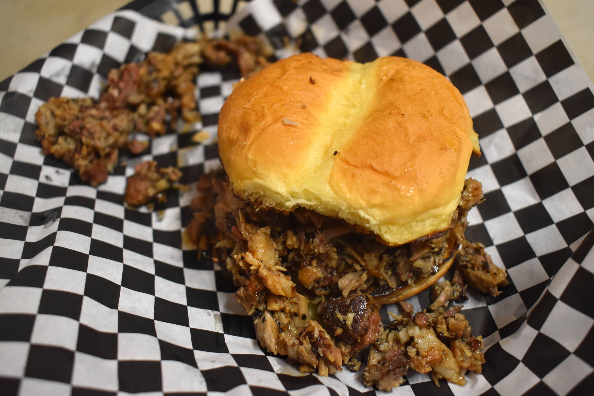 Matthew N. Wells / The Daily World
The brisket burger, specially cooked here, has a slightly spicy mop sauce that compliments the chopped brisket, which is delicious.