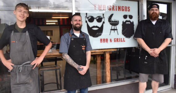 Matthew N. Wells / The Daily World
The Two Gringos, Travis Haney, center, and Steven Eddy, right, make killer barbecue in downtown Hoquiam — 409 7th Street. Lyle Witt, left, works hard in back.