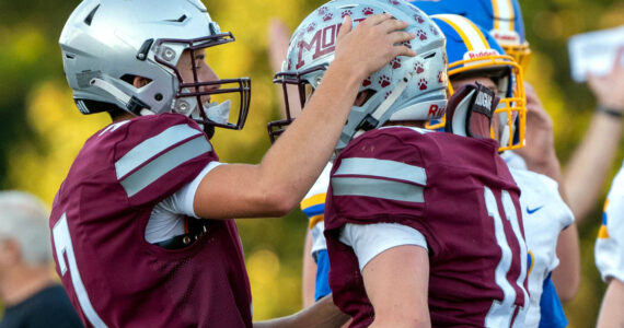 PHOTO BY FOREST WORGUM Montesano quarterback Tyson Perry (left) celebrates with running back Gabe Pyhala during the Montesano Football Jamboree on Friday in Montesano.