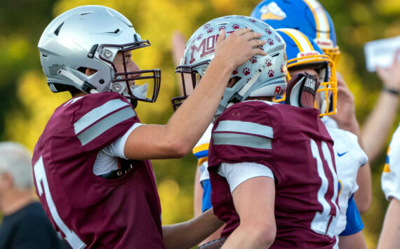 PHOTO BY FOREST WORGUM Montesano quarterback Tyson Perry (left) celebrates with running back Gabe Pyhala during the Montesano Football Jamboree on Friday in Montesano.