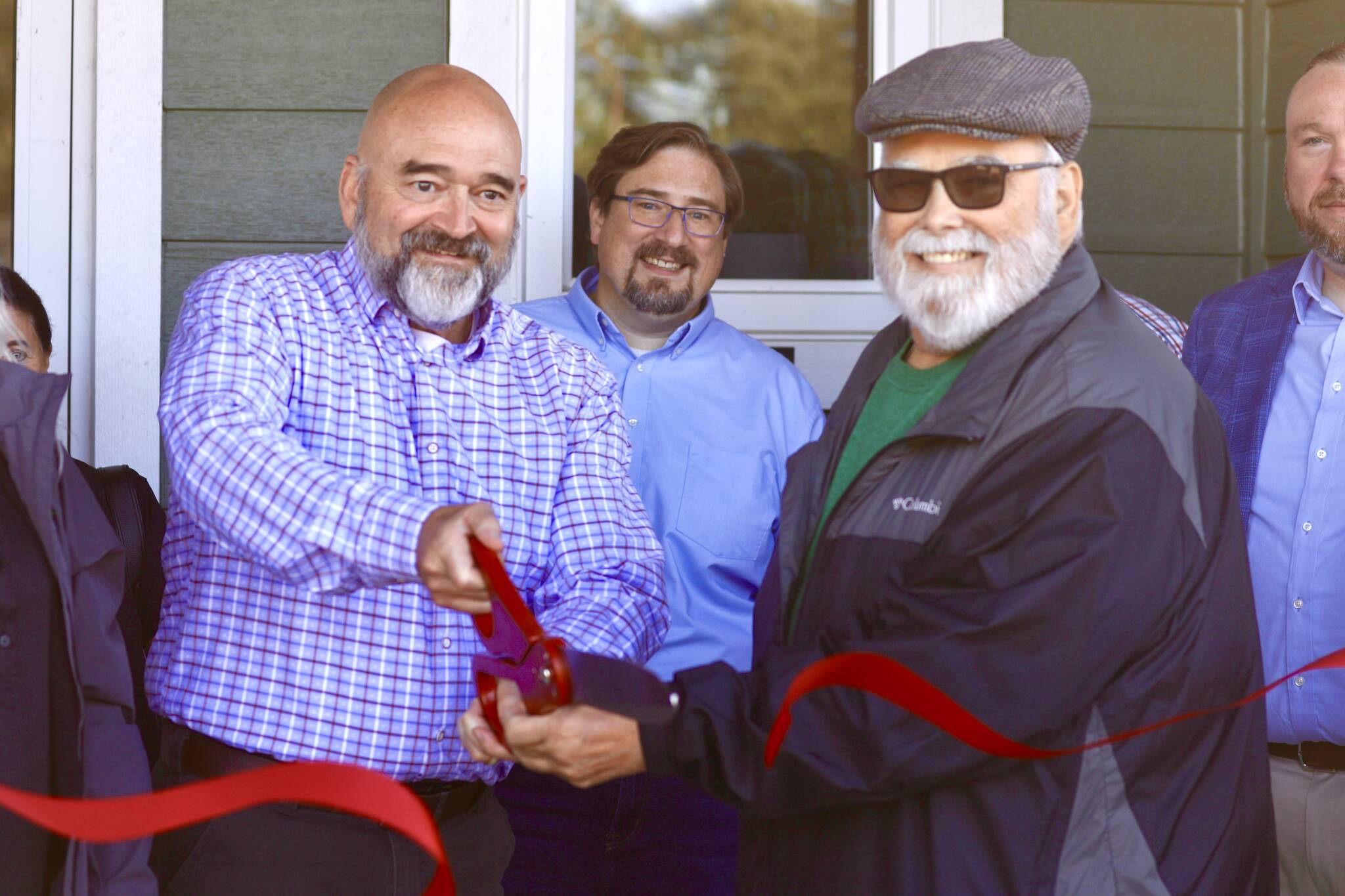 Westport city administrator Kevin Goodrich and hospital commissioner Michael Bruce cut the ceremonial ribbon opening a new clinic in Westport. (Michael S. Lockett / The Daily World)