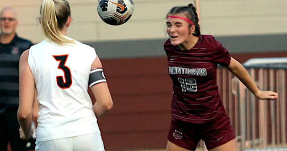 RYAN SPARKS | THE DAILY WORLD Montesano defender Emily Kuntz (18) heads the ball against Napavine’s Hayden Kaut during the Bulldogs’ 5-0 win on Thursday at Montesano High School.