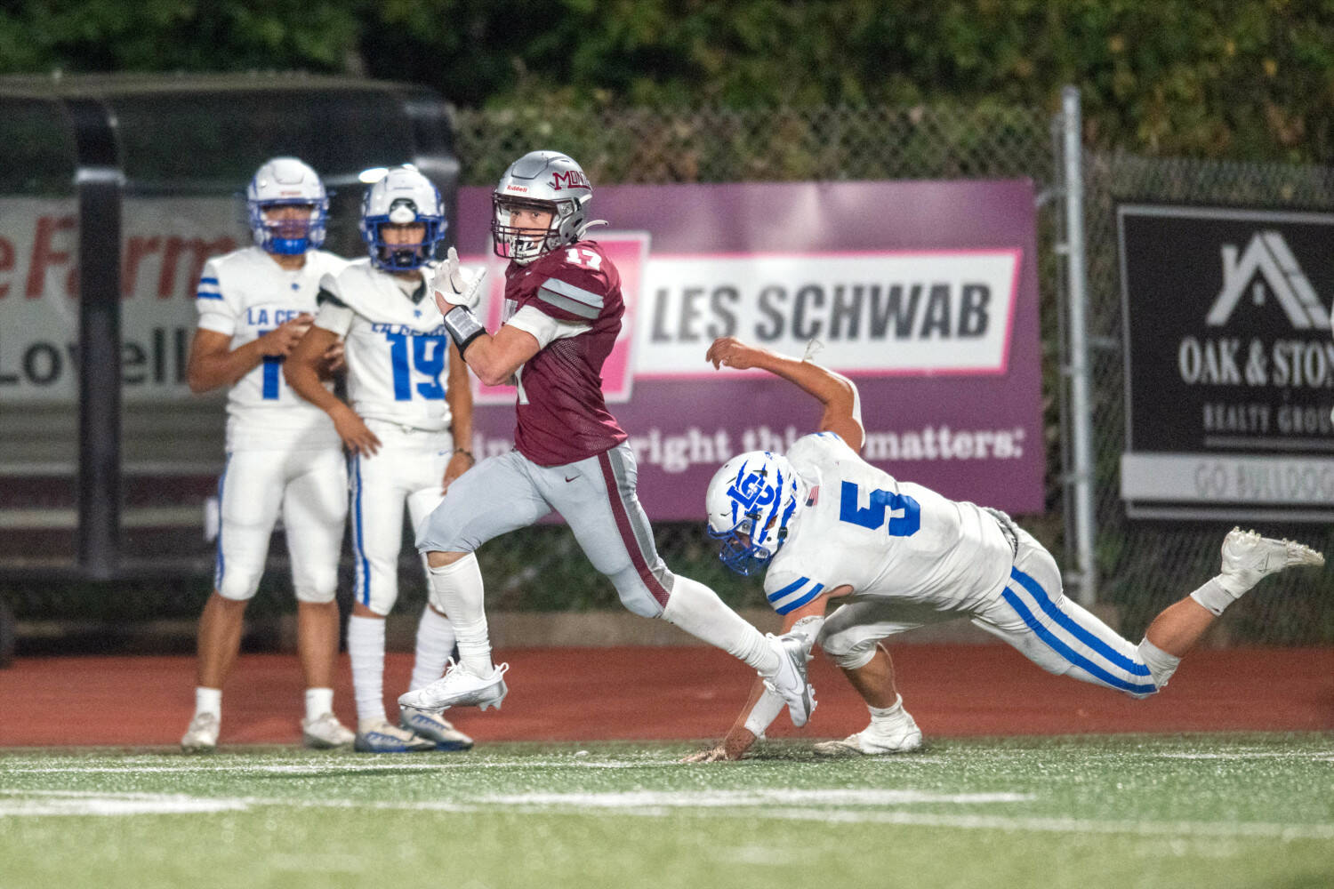 PHOTO BY FOREST WORGUM Montesano’s Toren Crites (left) sprints away from La Center’s Wyatt Eiesland (5) during the Bulldogs’ 35-7 loss on Friday at Montesano High School.