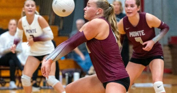 PHOTO BY FOREST WORGUM Montesano outside hitter Kalia Hatton (right) records a dig during the Bulldogs’ 3-0 loss to Adna on Monday at Montesano High School.