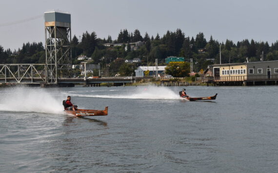 Matthew N. Wells / The Daily World
Todd Pickernell, in the canoe named “Norm Sr.,” left, races against a competitive field that included Arlen Sansom, who is in the canoe marked “Fear This.” Pickernell finished in second place in the race.