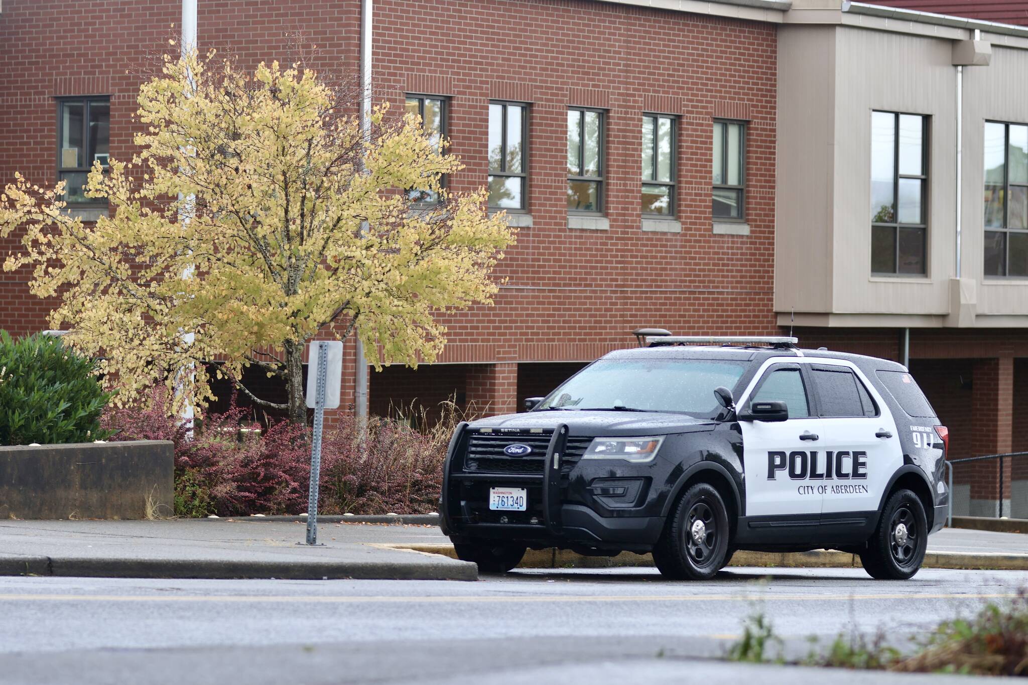 An Aberdeen police vehicle is one of the more visible components in the response after school administrators raised the security levels following a report that an unknown person was going to bring a gun to Aberdeen High School. (Michael S. Lockett / The Daily World)