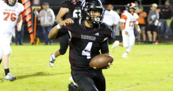 RYAN SPARKS | THE DAILY WORLD Raymond-South Bend quarterback Chris Quintana finds running room during a 43-34 loss to Rainier on Friday at Raymond High School.