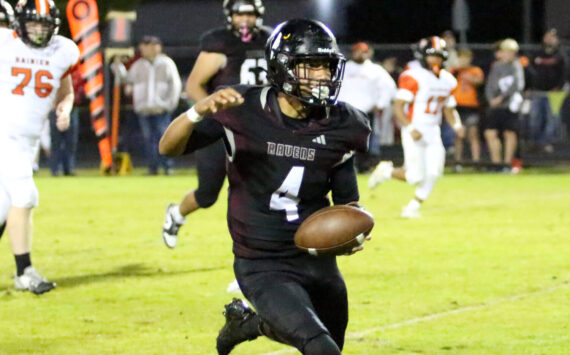 RYAN SPARKS | THE DAILY WORLD Raymond-South Bend quarterback Chris Quintana finds running room during a 43-34 loss to Rainier on Friday at Raymond High School.