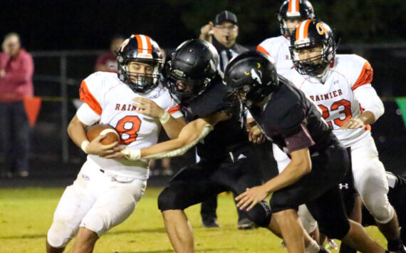 RYAN SPARKS | THE DAILY WORLD Rainier running back Dorien Cano (8) is tackled by Raymond-South Bend’s Isaac Schlueter (right) and Chris Banker during the Ravens’ 43-34 loss on Friday in Raymond.