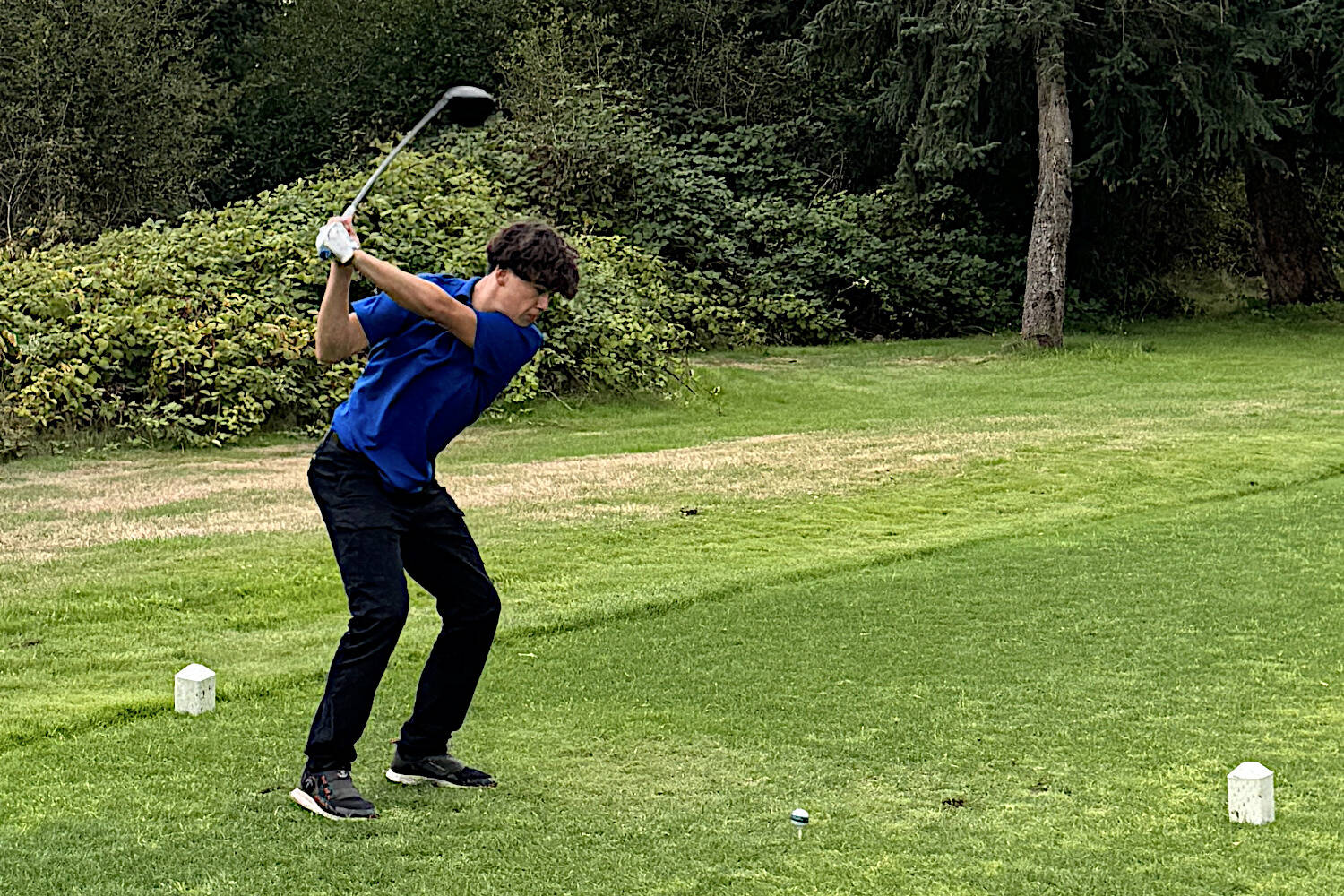 SUBMITTED PHOTO Elma’s Robby Allen hits from the tee box during a match against Hoquiam on Wednesday at the Oaksridge Golf Course in Elma.