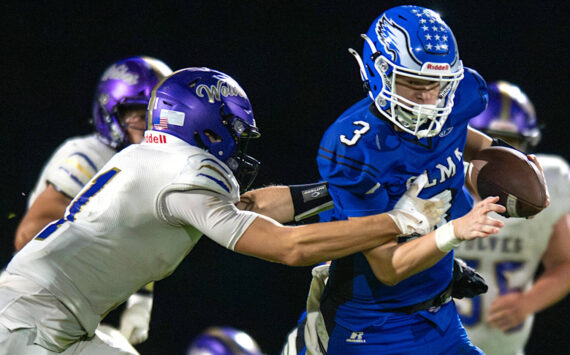 PHOTO BY FOREST WORGUM Elma quarterback Isaac McGaffey (3) attempts to get away from a Sequim defender during a 28-7 loss on Friday at Davis Field in Elma.