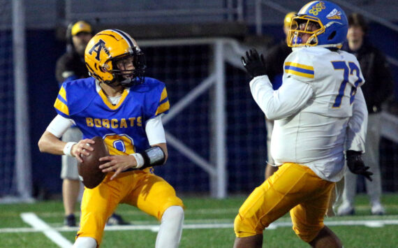 RYAN SPARKS | THE DAILY WORLD Aberdeen quarterback Mason Hill (left) prepares to throw while chased by Rochester defensive lineman Nicolas Mendiola during a 33-7 loss on Friday at Stewart Field in Aberdeen.