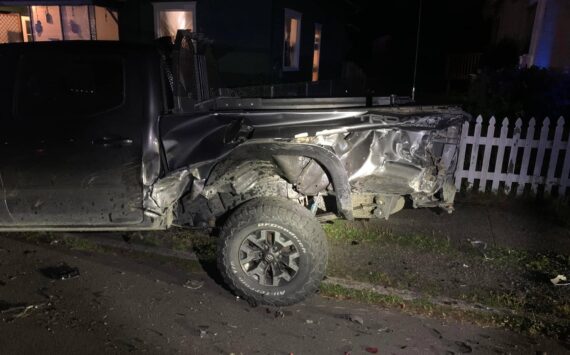 Damage from a crash involving a former mayor of Aberdeen is apparent on a parked car. (Courtesy photo / Josh Conway)