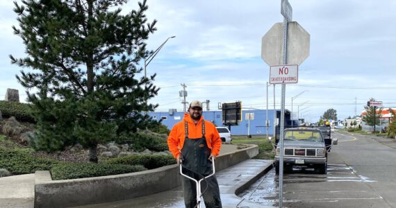 City of Aberdeen
Craig Yakovich, recreation supervisor for Aberdeen Parks and Recreation department, power-washes the sidewalk in front of “Breaker,” the art project that sits alongside Simpson Avenue’s bend.