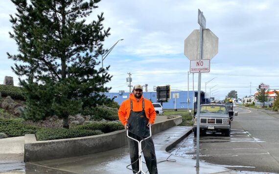 City of Aberdeen
Craig Yakovich, recreation supervisor for Aberdeen Parks and Recreation department, power-washes the sidewalk in front of “Breaker,” the art project that sits alongside Simpson Avenue’s bend.