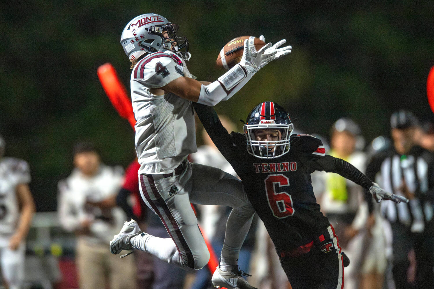 PHOTO BY FOREST WORGUM Montesano’s Zach Timmons (4) leaps over Tenino defender Austin Johnson during the Bulldogs’ 31-13 victory on Friday in Tenino.