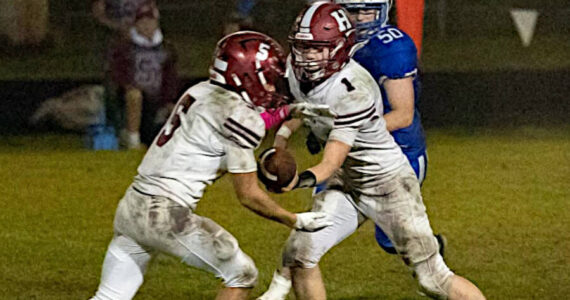 PHOTO BY PATTI REYNVAAN 
Hoquiam quarterback Joey Bozich (1) hands off to running back Kingston Case (5) during the Grizzlies’ 14-13 win over Toutle Lake on Friday at Toutle Lake High School.