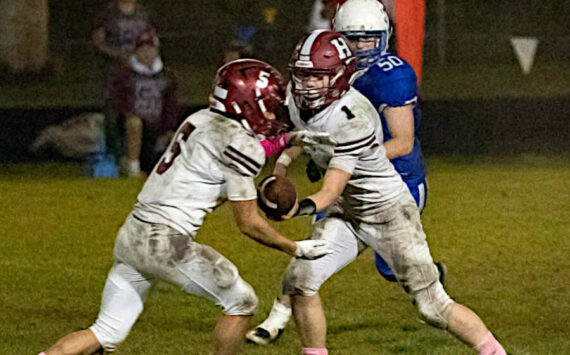 PHOTO BY PATTI REYNVAAN 
Hoquiam quarterback Joey Bozich (1) hands off to running back Kingston Case (5) during the Grizzlies’ 14-13 win over Toutle Lake on Friday at Toutle Lake High School.