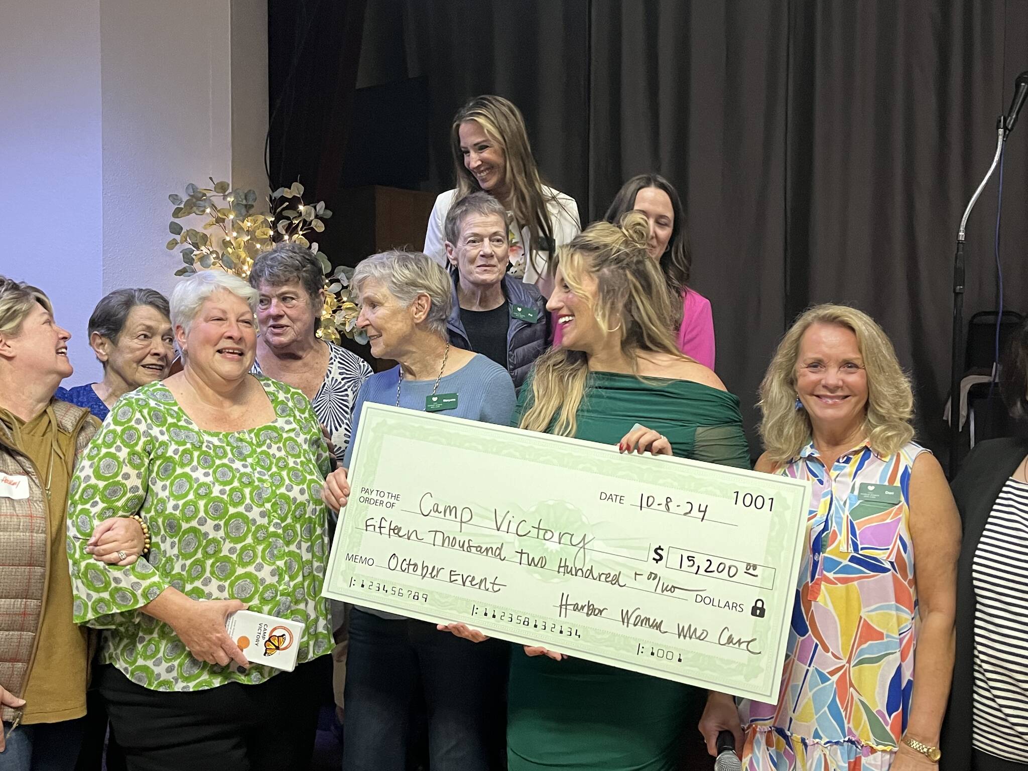 Matthew N. Wells / The Daily World
In addition to the $15,200 listed on this check that 100+ Harbor Women Who Care helped raise, the group was able to raise an extra $3,220 by Wednesday afternoon. Andrea Seabert, who is holding brochures for the winning nonprofit Camp Victory, stands with many of the 100+ Harbor Women Who Care core members. The core has stayed the same since the group started in 2019.