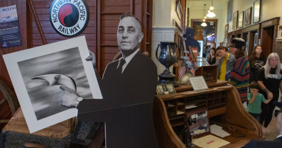 Owen Sexton / The Chronicle
A cardboard cutout of Chehalis pilot Kenneth Arnold greets visitors to the Lewis County Historical Museum on Saturday, Sept. 14, during the Chehalis Flying Saucer Party with an artist rendering of the craft he saw while flying in 1947.