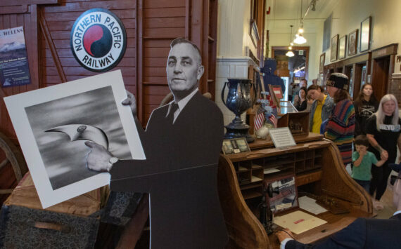 Owen Sexton / The Chronicle
A cardboard cutout of Chehalis pilot Kenneth Arnold greets visitors to the Lewis County Historical Museum on Saturday, Sept. 14, during the Chehalis Flying Saucer Party with an artist rendering of the craft he saw while flying in 1947.