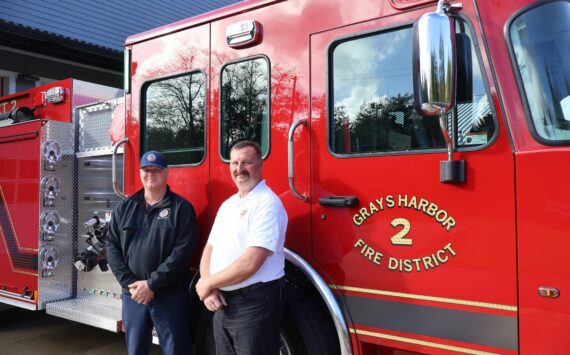 Michael S. Lockett / The Daily World
Grays Harbor Fire District 2 Chief John McNutt, right, and firefighter and district mechanic Casey Hogarty, left, pose in front of the district’s new engine.