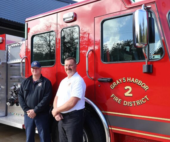 Michael S. Lockett / The Daily World
Grays Harbor Fire District 2 Chief John McNutt, right, and firefighter and district mechanic Casey Hogarty, left, pose in front of the district’s new engine.