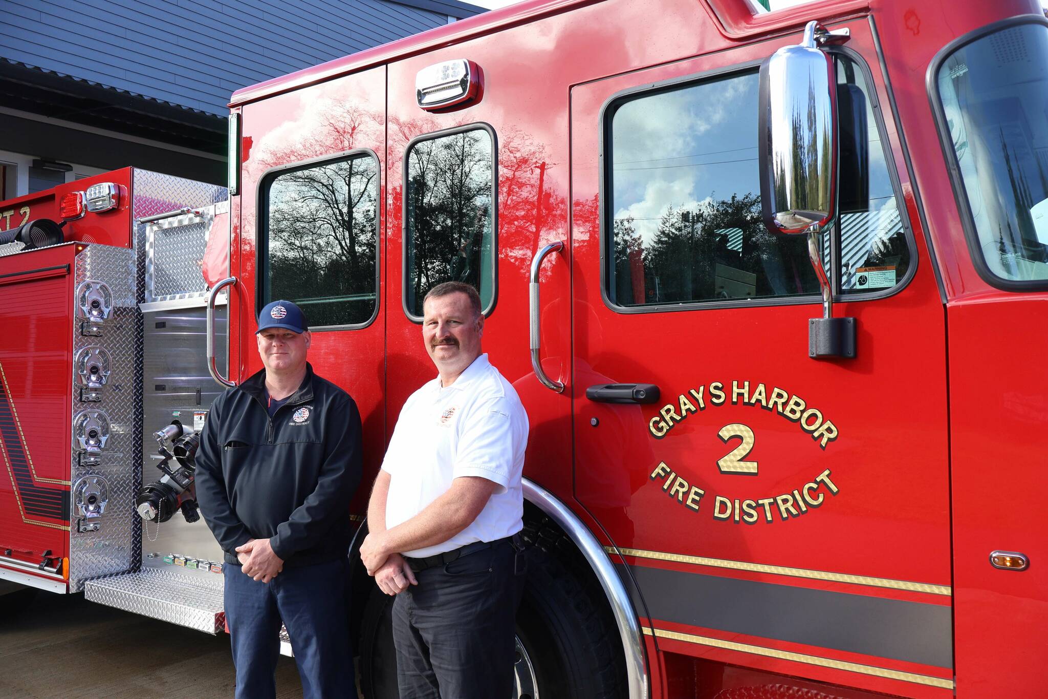 Michael S. Lockett / The Daily World
Grays Harbor Fire District 2 Chief John McNutt, right, and firefighter and district mechanic Casey Hogarty, left, pose in front of the district’s new engine.