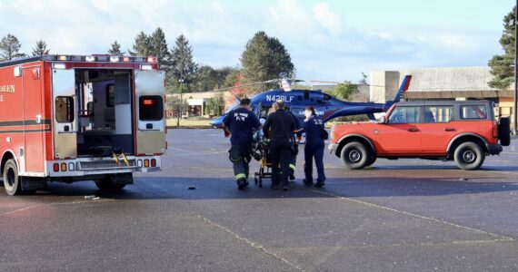 Michael S. Lockett / The Daily World
Firefighters and flight nurses wheel a patient to a Life Flight Network helicopter for medevac on Thursday morning in South Aberdeen.