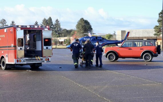 Michael S. Lockett / The Daily World
Firefighters and flight nurses wheel a patient to a Life Flight Network helicopter for medevac on Thursday morning in South Aberdeen.