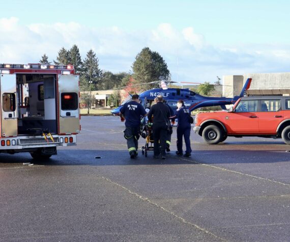 Michael S. Lockett / The Daily World
Firefighters and flight nurses wheel a patient to a Life Flight Network helicopter for medevac on Thursday morning in South Aberdeen.