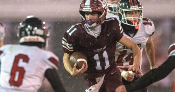 PHOTO BY FOREST WORGUM
Hoquiam quarterback Ethan Byron (11) looks for running room against the Tenino defense in a 36-7 loss on Friday in Hoquiam.