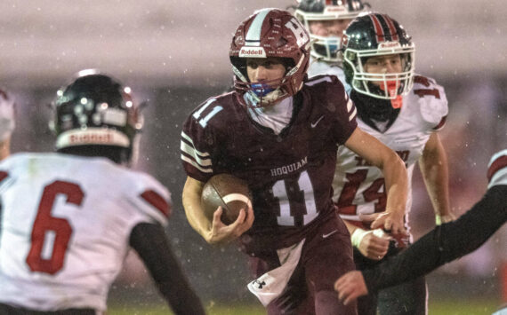 PHOTO BY FOREST WORGUM
Hoquiam quarterback Ethan Byron (11) looks for running room against the Tenino defense in a 36-7 loss on Friday in Hoquiam.