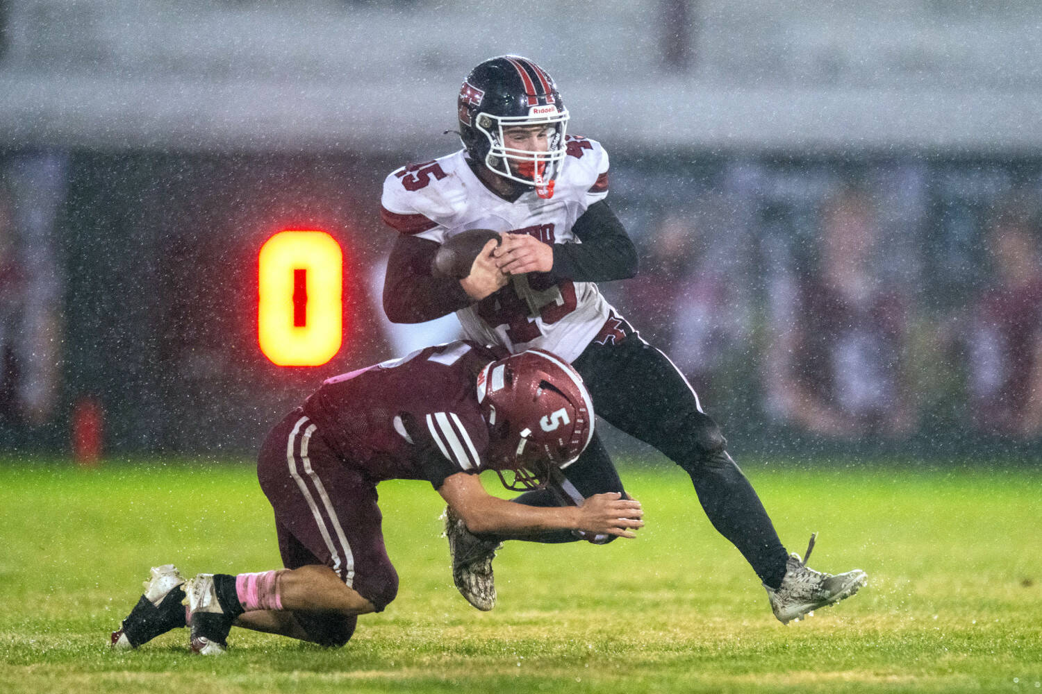 PHOTO BY FOREST WORGUM Hoquiam’s Kingston Case (5) tackles Tenino fullback Parker Minerich during a 36-7 loss on Friday at Olympic Stadium in Hoquiam.