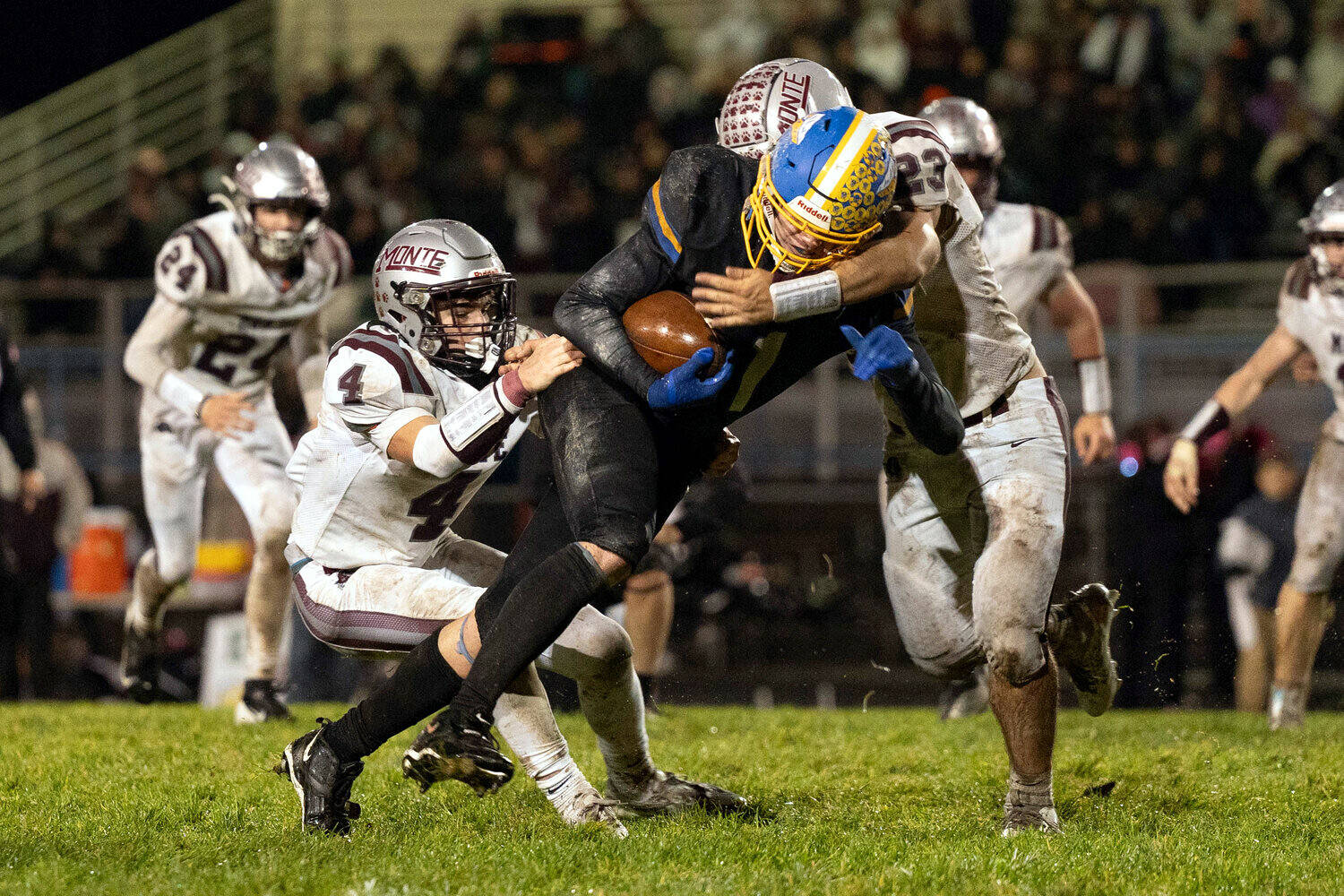 KODY CHRISTEN | THE CHRONICLE Rochester’s Ethan Rodriguez runs against Montesano defenders Zach Timmons (4) and Marcus Hale during the Bulldogs’ 16-12 loss on Friday in Rochester.