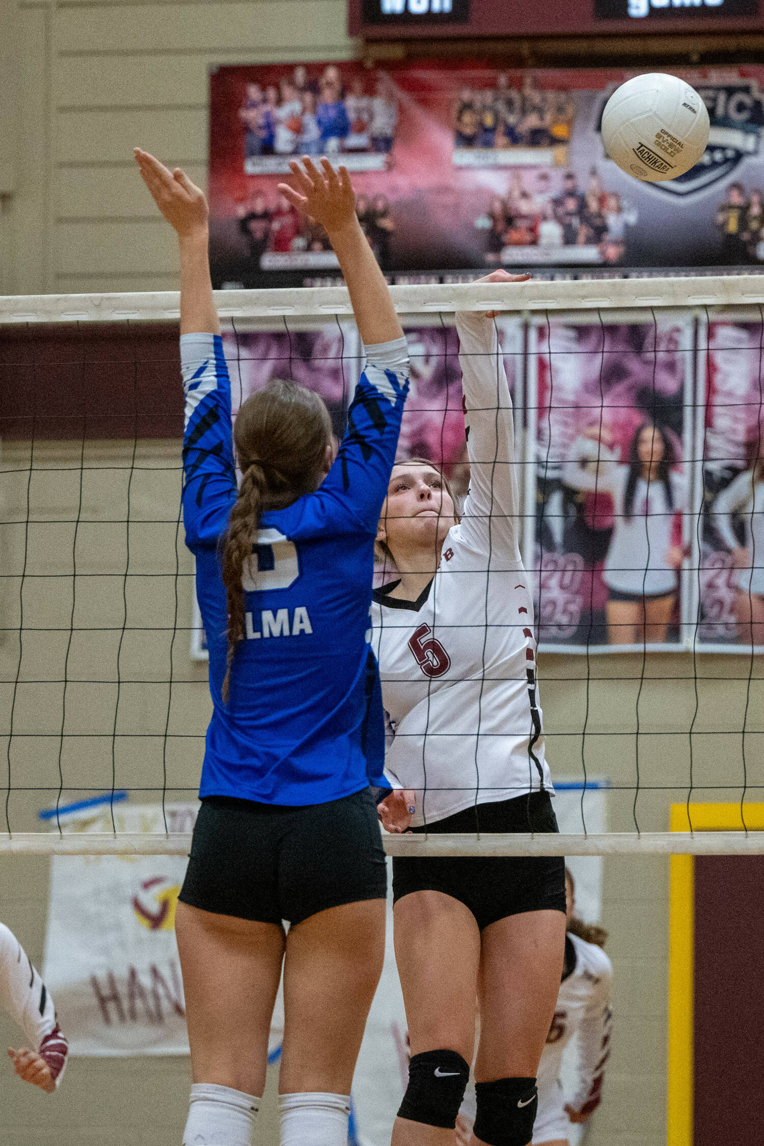 PHOTO BY FOREST WORGUM Raymond-South Bend middle blocker Ava Baugher (5) attempts a kill against Elma’s Haydenne Bogar during the Ravens’ 3-0 win on Monday in South Bend.