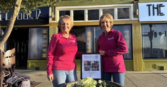 Matthew N. Wells / The Daily World
Bobbi McCracken, left, and Bette Worth stand behind their work as they show off their statewide award they received in Walla Walla on Oct. 17. The 2024 Excellence on Main Award for Organization Excellence, given by the Washington State Main Street Program, is specifically for Aberdeen Bloom Team. But, it also recognizes all the other work the duo, and their team, contributes through Downtown Aberdeen Association.