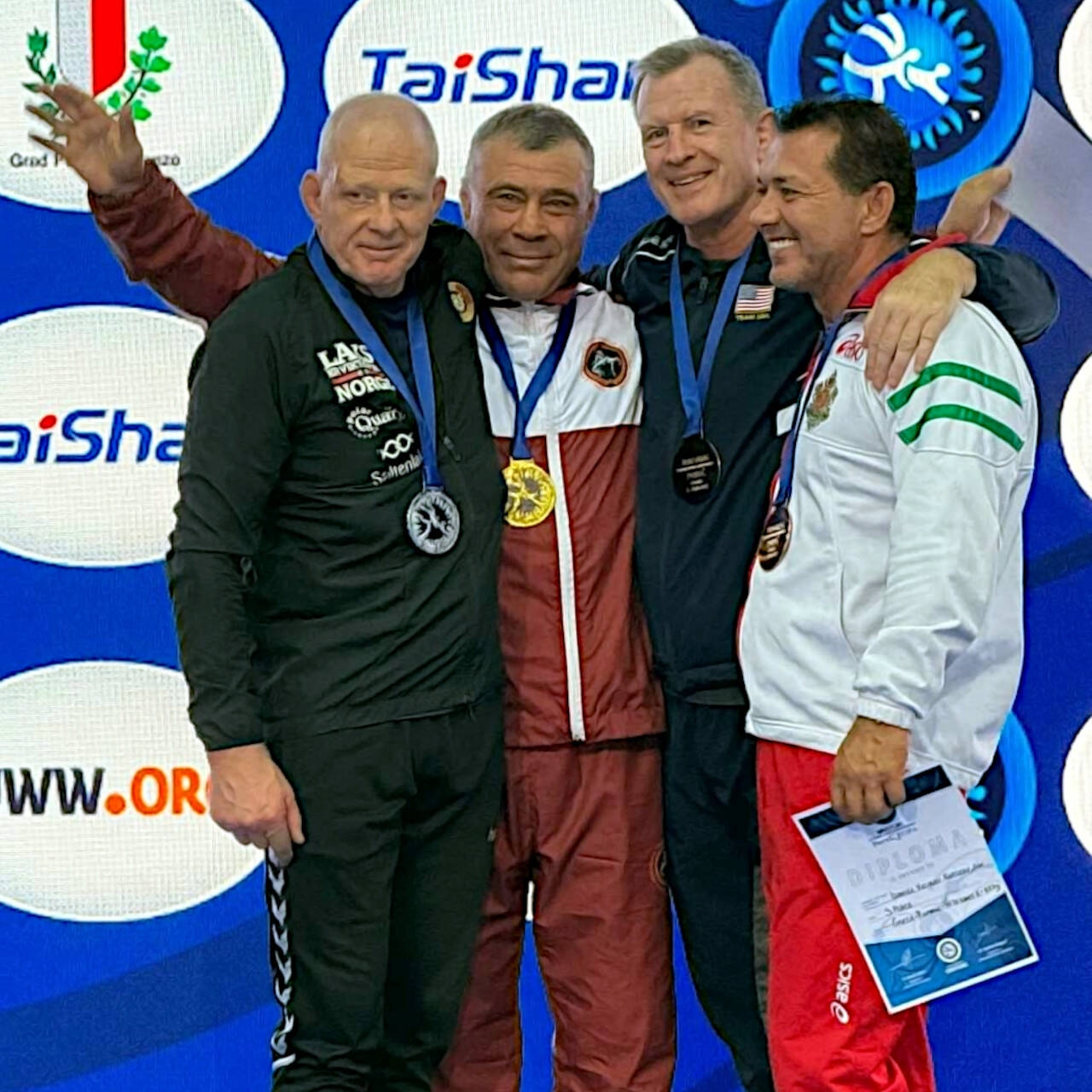 SUBMITTED PHOTO Elma’s Kevin Pine (second from right) stands with (from left) Norway’s Martin Dalsbotten, Russia’s Igor Dokuchaev, and Bulgaria’s Daniel Kapsazov at the conclusion of the 88kg Greco-Roman competition at the United World Wrestling Veterans World Championships on Oct. 8-13 in Poreč, Croatia.