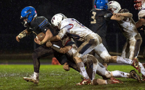 KODY CHRISTEN | THE CHRONICLE Adna’s Luke Mohney (left) is tackled by Pe Ell-Willapa Valley’s Cody Mican (10) during the Titans’ 14-0 loss on Thursday in Adna.