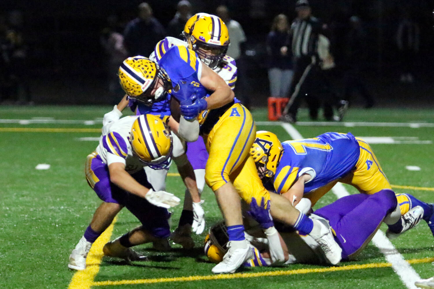 RYAN SPARKS | THE DAILY WORLD Aberdeen running back Micah Schroeder (middle) bulldozes a Columbia River defender during the Bobcats’ 7-6 loss in a 2A State play-in matchup on Tuesday at Stewart Field in Aberdeen.