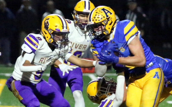 RYAN SPARKS | THE DAILY WORLD Aberdeen running back Micah Schroeder (right) carries the ball against Columbia River defensive back Aedan Pena during the Bobcats’ 7-6 loss in a 2A State play-in matchup on Tuesday at Stewart Field in Aberdeen.