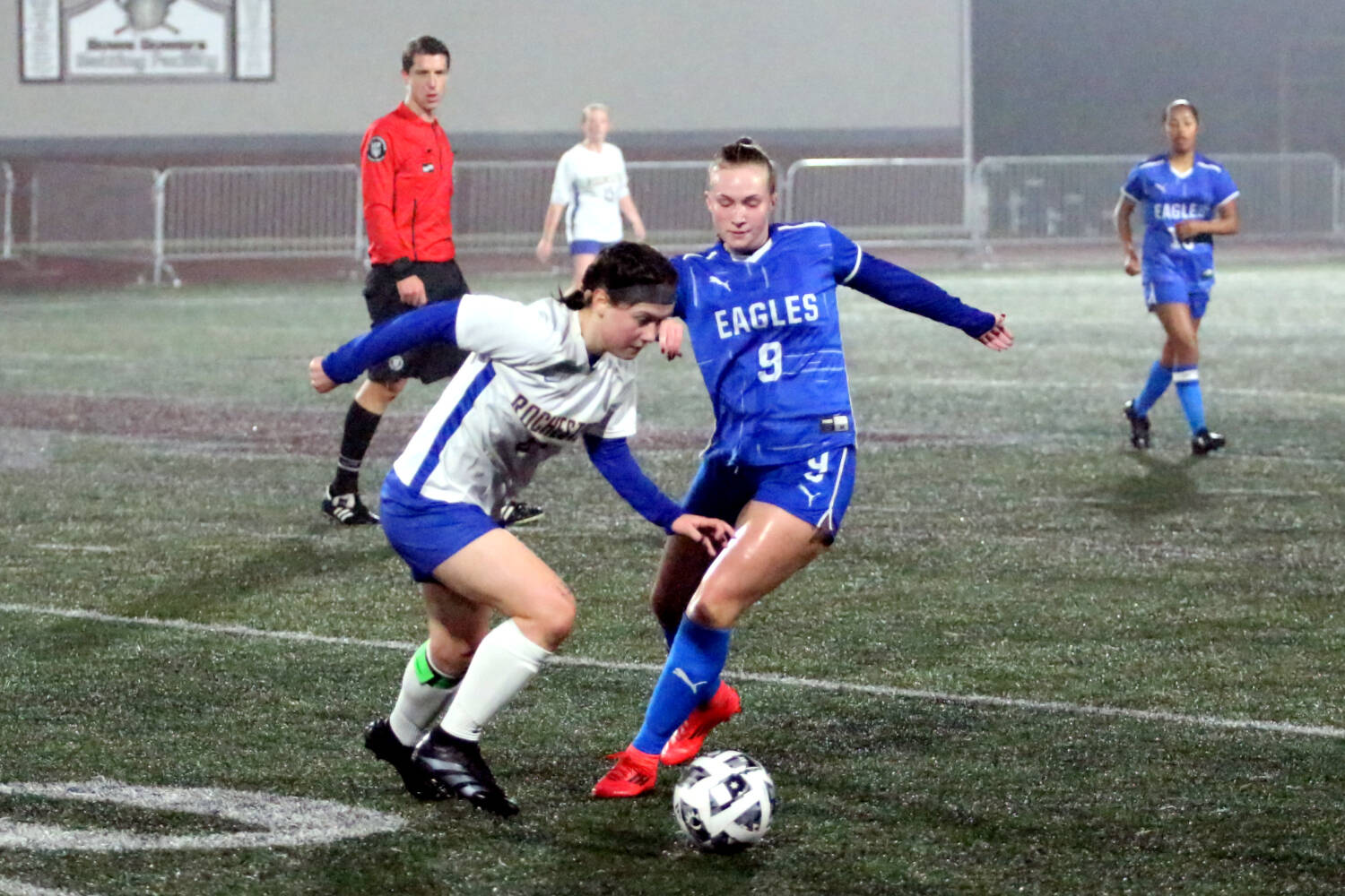 RYAN SPARKS | THE DAILY WORLD Elma midfielder Miley Seaberg (9) battles for possession with Rochester’s Emily Beasley during the Eagles’ 2-0 victory in a 1A District 4 elimination game on Saturday in Montesano.