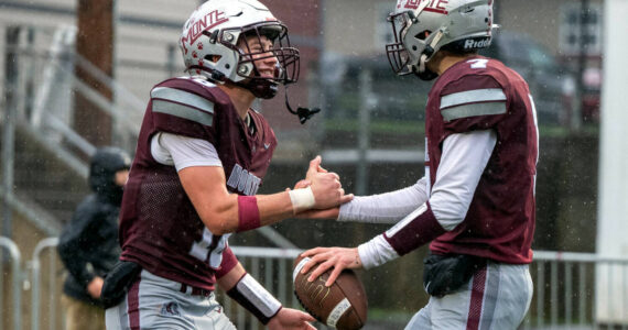 PHOTO BY FOREST WORGUM 
Montesano receiver Mason Rasmussen (left) celebrates with quarterback Tyson Perry after Perry scored a touchdown in a 31-7 win over Omak on Saturday. The Bulldogs face La Center in a 1A State quarterfinal game on Saturday at Woodland High School.