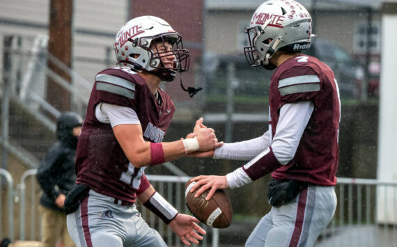 PHOTO BY FOREST WORGUM 
Montesano receiver Mason Rasmussen (left) celebrates with quarterback Tyson Perry after Perry scored a touchdown in a 31-7 win over Omak on Saturday. The Bulldogs face La Center in a 1A State quarterfinal game on Saturday at Woodland High School.